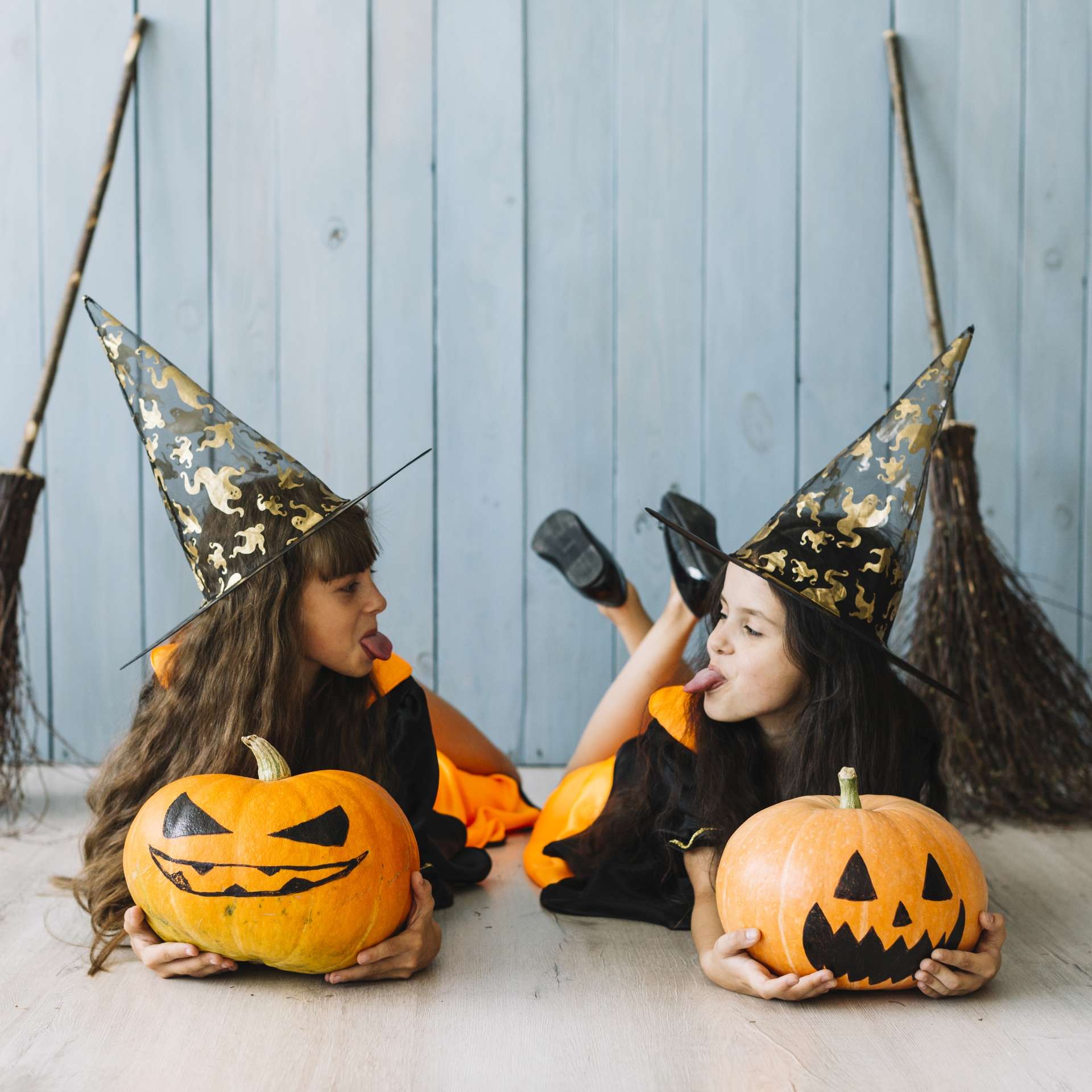 girls-witch-costumes-lying-putting-out-tongues.jpg